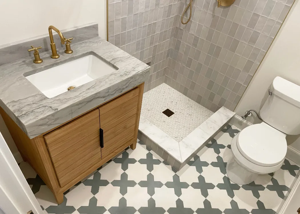 Bathroom remodeling project completed by TEKRA Builders that features intricate tile design